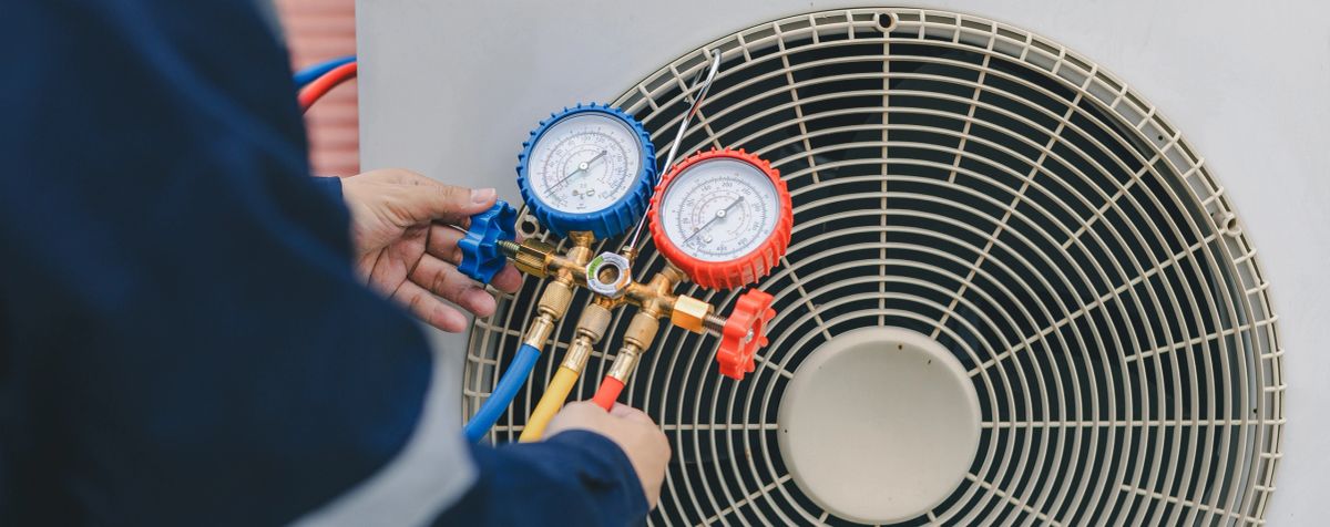 Homeowner adjusting a wall mounted air conditioning unit